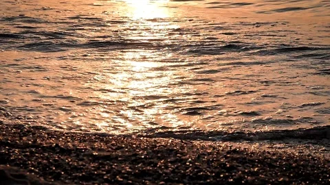 The waves of the sea bat in the sand at sunset sunrise in slowmotion 180 fps Stock Footage