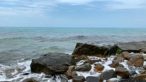 Waves on the sea beat against the rocks on the shore. Stock Footage 141003143