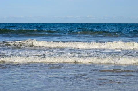 Waves in the sea with blue sky as background Stock Photos