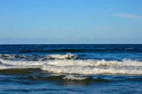 Waves in the sea with blue sky as background Stock Photos