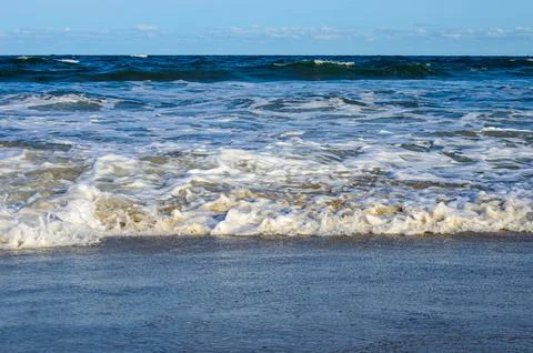 Waves in the sea with blue sky as background Stock Photos