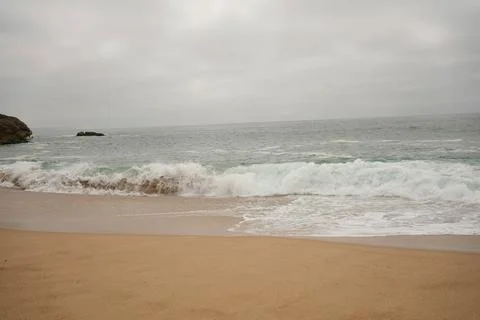 Waves of the sea on a cloudy day Stock Photos