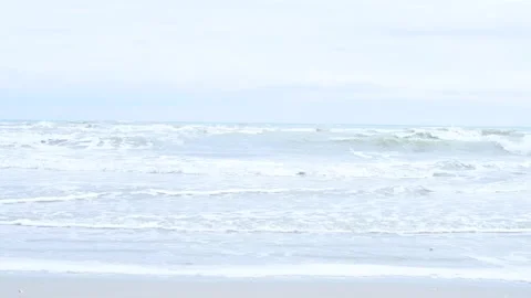 Waves of the sea on a cloudy day. Sandy embankment in Italy. Stock Footage 131697287