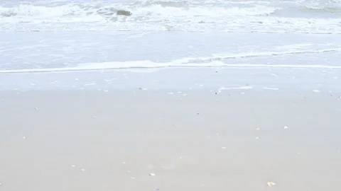 Waves of the sea on a cloudy day. Sandy embankment in Italy. Stock Footage 132393267