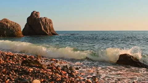 Waves on the sea coast at sunset. Slow motion. Stock Footage 180547606