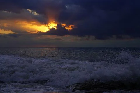 Waves at sea during sunset Stock Photos