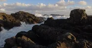 Waves With Sea Foam Splashing On Rocky Coastline Stock Footage
