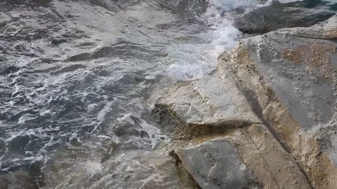 Waves of the sea gently lapping the cliff 4338 Stock Footage 107399567