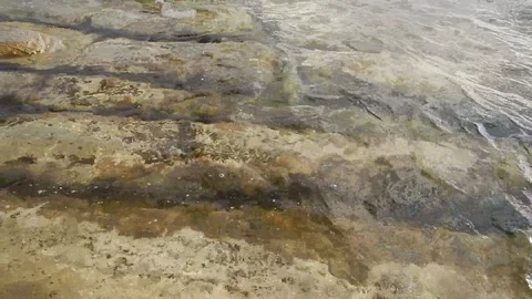 Waves of the sea gently lapping the cliff 4340 Stock Footage 107399698