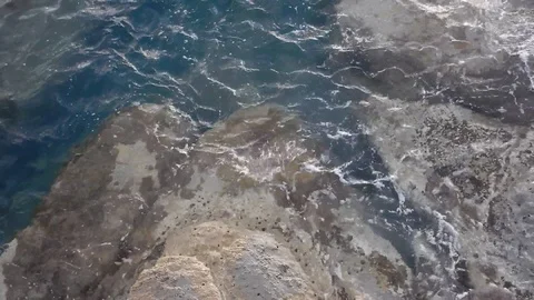 Waves of the sea gently lapping the cliff 4329 Video stock 107400239