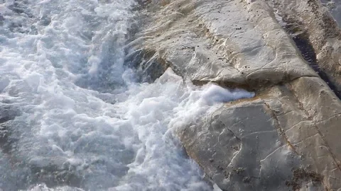 Waves of the sea gently lapping the cliff 4335 Video stock 107400281