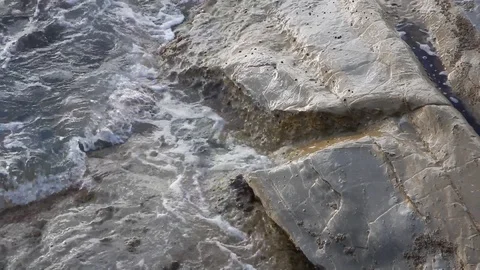Waves of the sea gently lapping the cliff 4336 Stock Footage 107400379