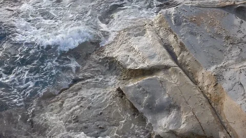 Waves of the sea gently lapping the cliff 4334 Video stock 107400537