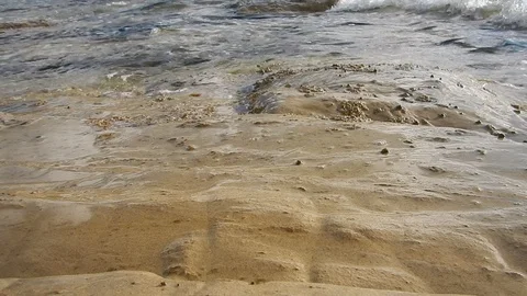 Waves of the sea gently lapping the sandstone cliff 4319 Stock Footage 107399930