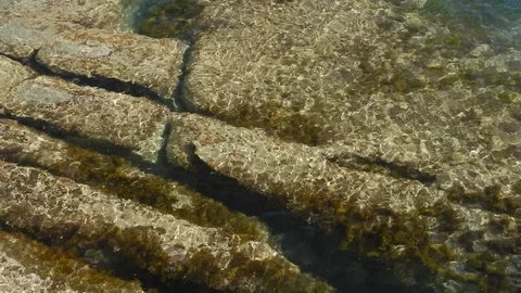 Waves of the sea gently lapping submersed cliff 4581 Stock Footage 107950416