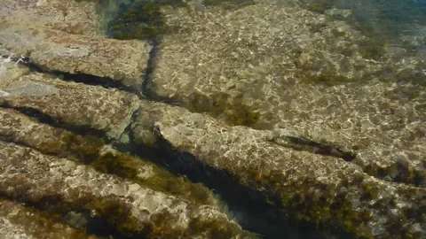 Waves of the sea gently lapping submersed cliff 4579 Stock Footage 107950427