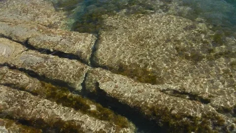 Waves of the sea gently lapping submersed cliff 4582 Stock Footage 107950639