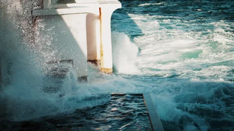 The waves of the sea hitting a wall in daylight Stock Footage 301689741