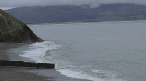 Waves on the sea with mountains and clouds Stock Footage 49640454