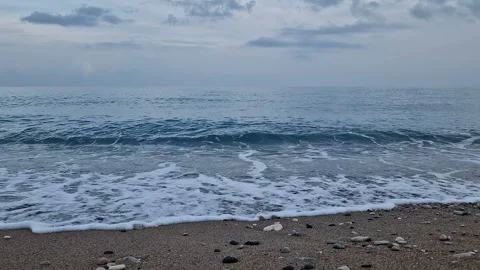 Waves in the sea. A pebble beach. The shore of the sea beach with waves in the Stock Footage 286126904