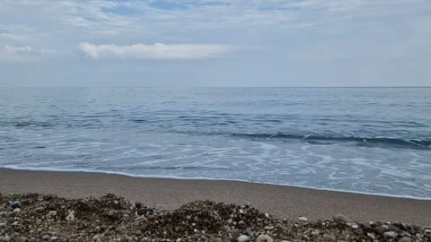 Waves in the sea. A pebble beach. The shore of the sea beach with waves in the Stock Footage 286128065