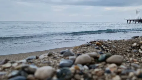 Waves in the sea. A pebble beach. The shore of the sea beach with waves in the Stock Footage 286330749