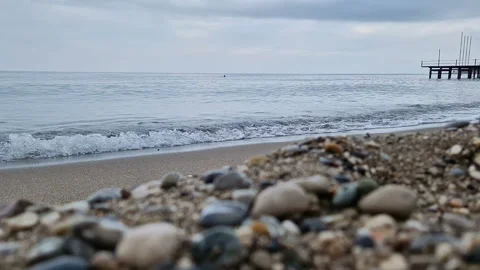 Waves in the sea. A pebble beach. The shore of the sea beach with waves in the Stock Footage 286331008