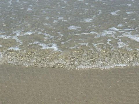 Waves of the Sea on the Sand Stock Photos