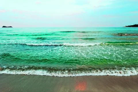 Waves of sea on the sandy beach Stock Photos