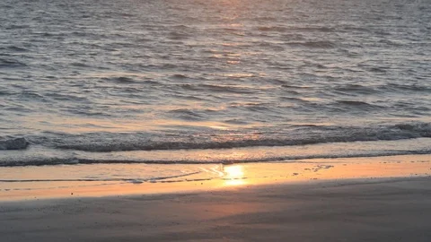 Waves of sea on sandy beach with sun reflection Stock Footage 115941571
