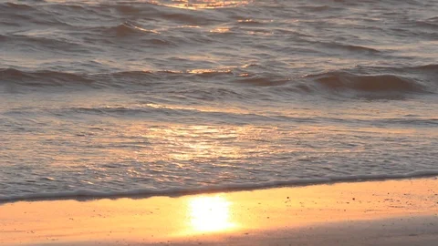Waves of sea on sandy beach with sun reflection Stock Footage 115941572