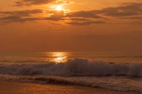 Waves in the sea with sunset. Stock Photos