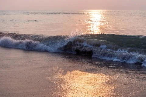 Waves in the sea with sunset. Stock Photos