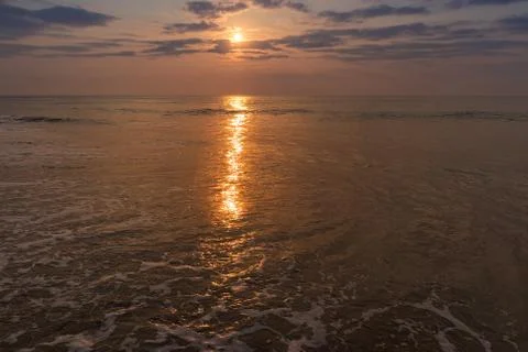 Waves in the sea with sunset. Stock Photos