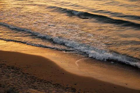 Waves of the sea at sunset Stock Photos