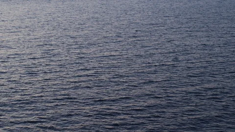 Waves on sea surface at dusk Stock Footage 100044639