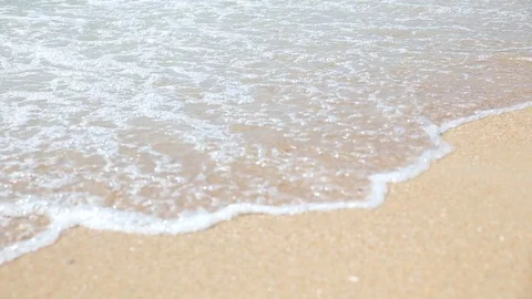 Waves on the seashore and human feet go along the shore and are washed by the Stock Footage 114178044