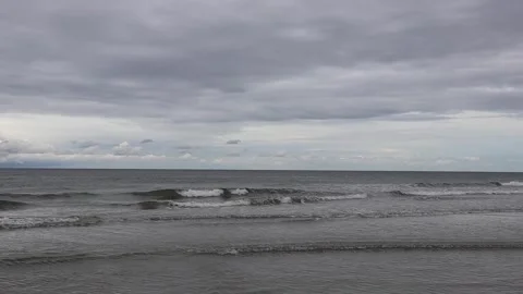 Waves on the seashore on a cloudy day Stock Footage 339619116