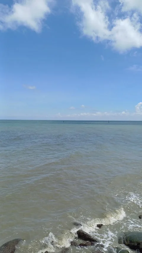 Waves on the seashore hit the rocks. Stock Footage 276835514