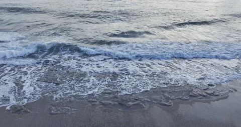 Waves on the seashore looking up to the horizon sunset Stock Footage 262488992