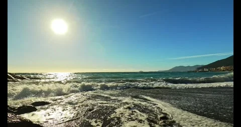 Waves on the seashore on a sunny day Stock Footage 313809350