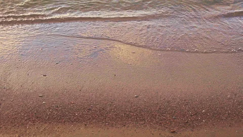 Waves on the seashore, waves roll on the sand on the shore, the beach is Stock Footage 158633091