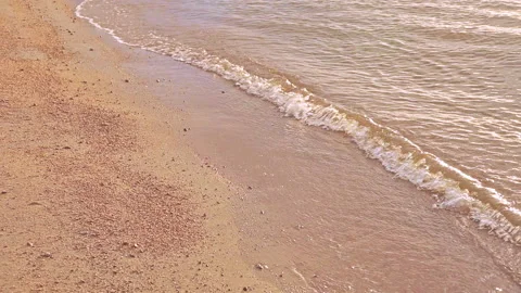 Waves on the seashore, waves roll on the sand on the shore, the beach is Stock Footage 158633153