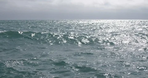 Waves shine in the sun against the background of the dark horizon Stock Footage 88442601