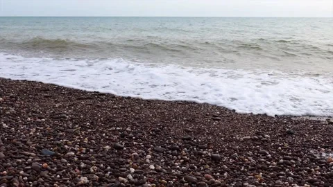 Waves on a shingle beach Stock Footage 132361409