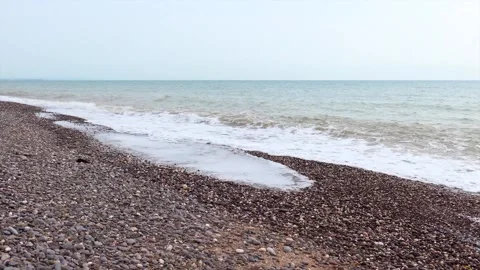 Waves on a shingle beach Stock Footage 132361583