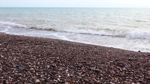 Waves on a shingle beach Stock Footage 132361706