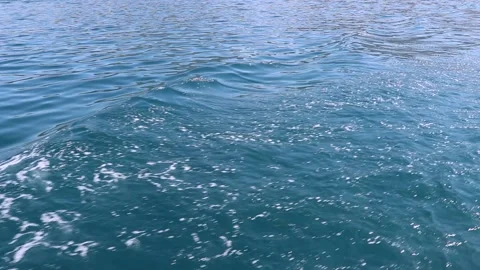 Waves from a ship carrying people Shine on the surface of the water glare re Stock Footage 128690680
