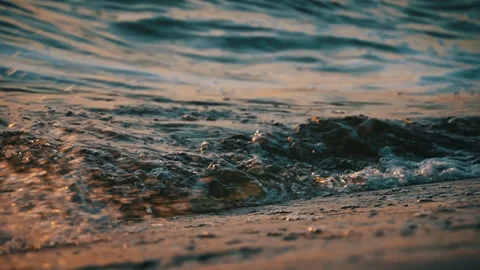 Waves on Shore with Reflection of the Sunset in Slow Motion Stock Footage 255548909