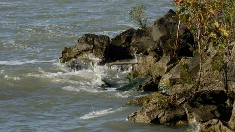 Waves in slow motion breaking against rocks on Lake Erie Stock Footage 82049467